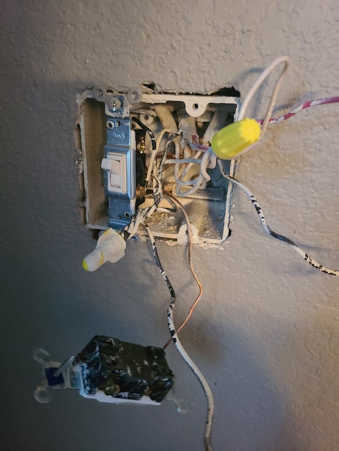 Exposed electrical wiring being inspected