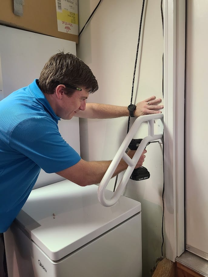 Tye installing a grab bar